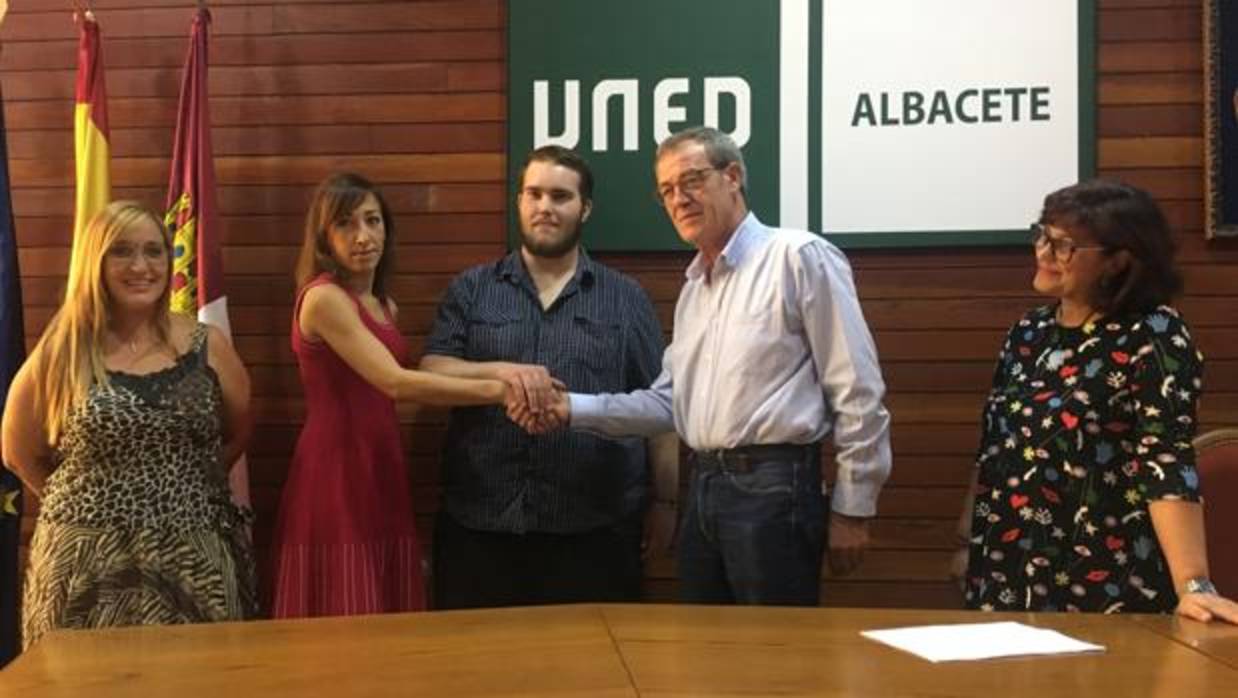La directora de la UNED en Albacete, Laura María Cabellos, estrecha la mano de representantes de Asprona