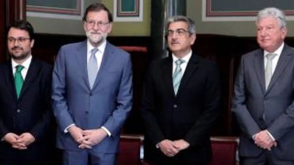 Rajoy, entre el líder del PP canario, Asier Antona; el presdiente de Nueva Canarias, Román Rodríguez, y su diputado, Pedro Quevedo, ayer en Las Palmas tras la firma del acuerdo presupuestario
