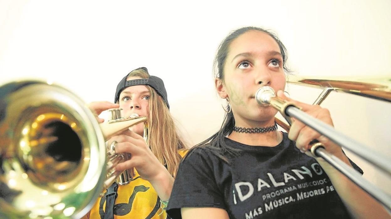 Dos niñas tocan instrumentos de viento