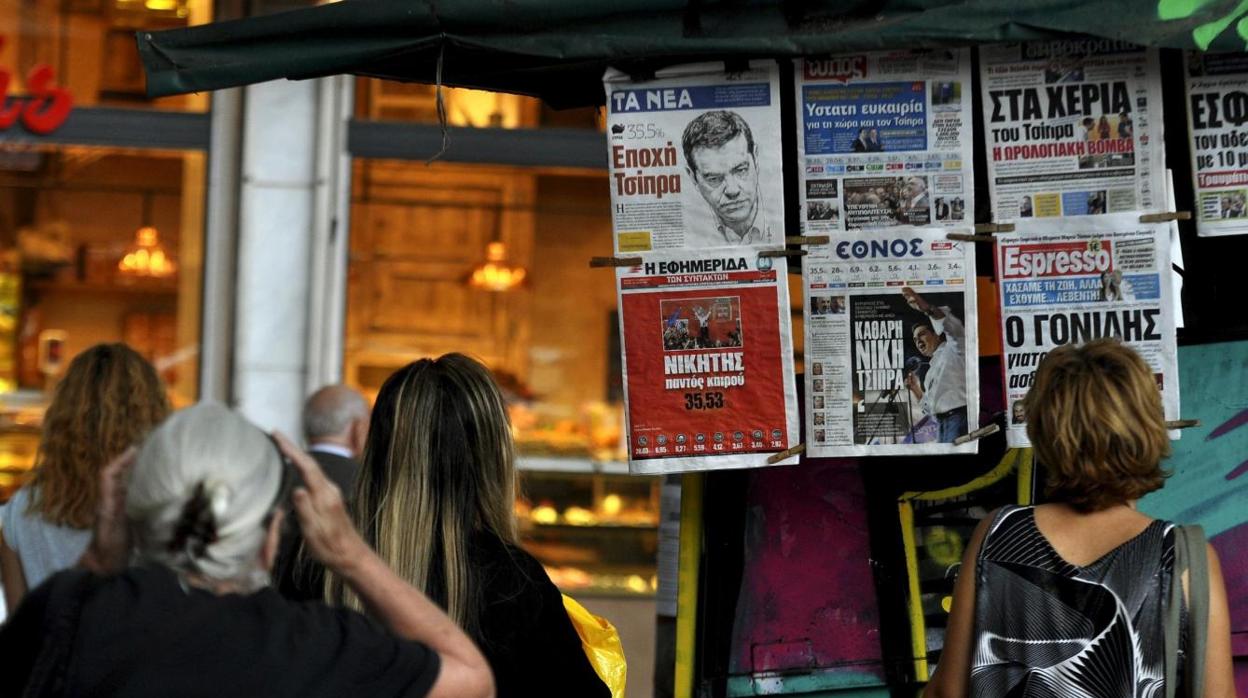 Griegos leyendo las portadas de la prensa
