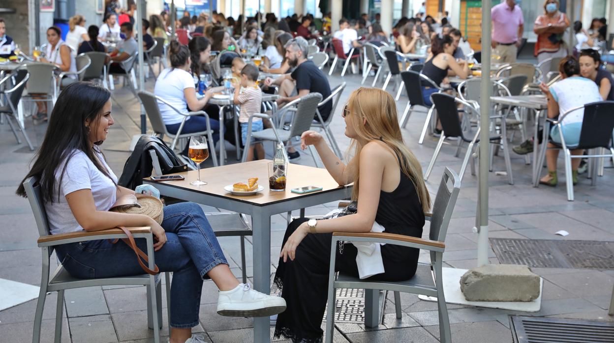 Jóvenes y familias sin mascarilla en una terraza en el centro de Valladolid