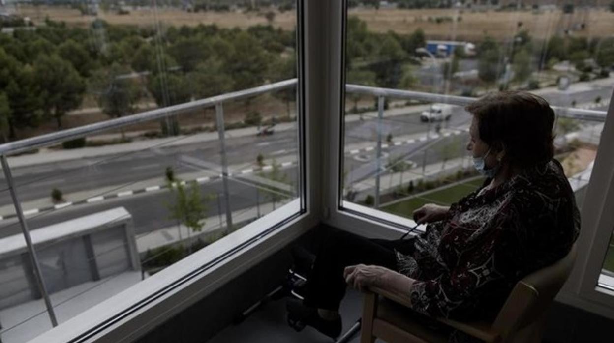 Una mujer mira por la ventana