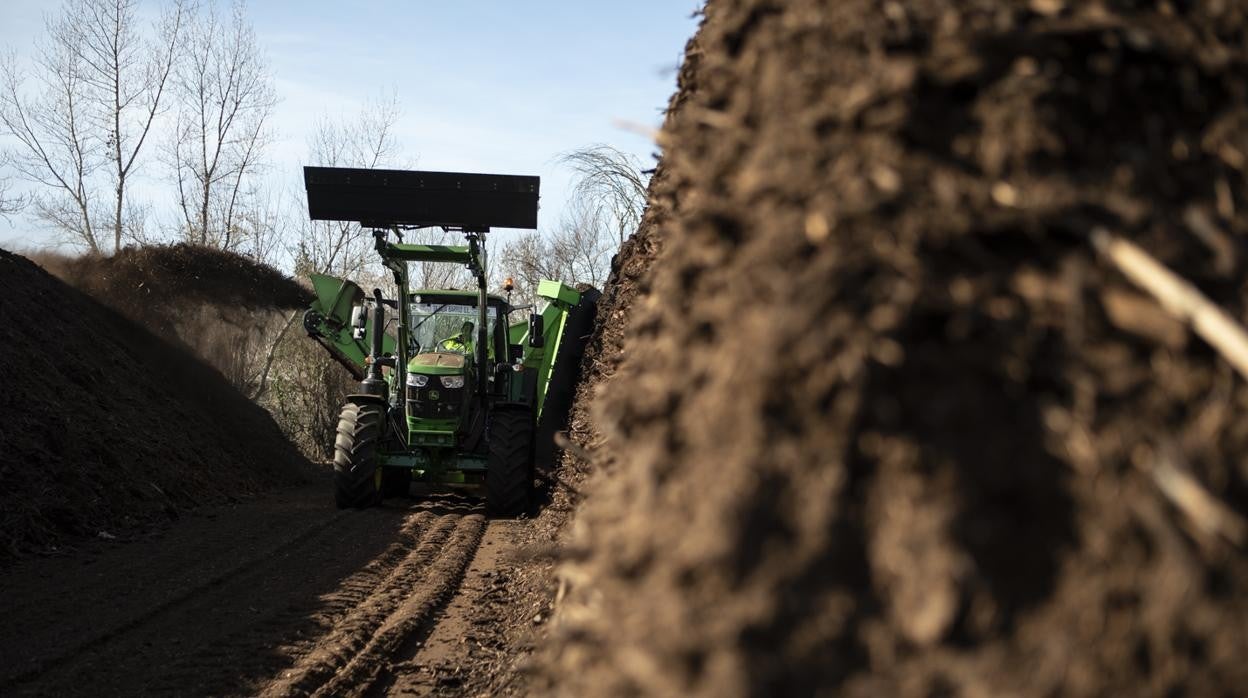 Una volteadora remueve el compost fermentado en la planta de Migas Calientes
