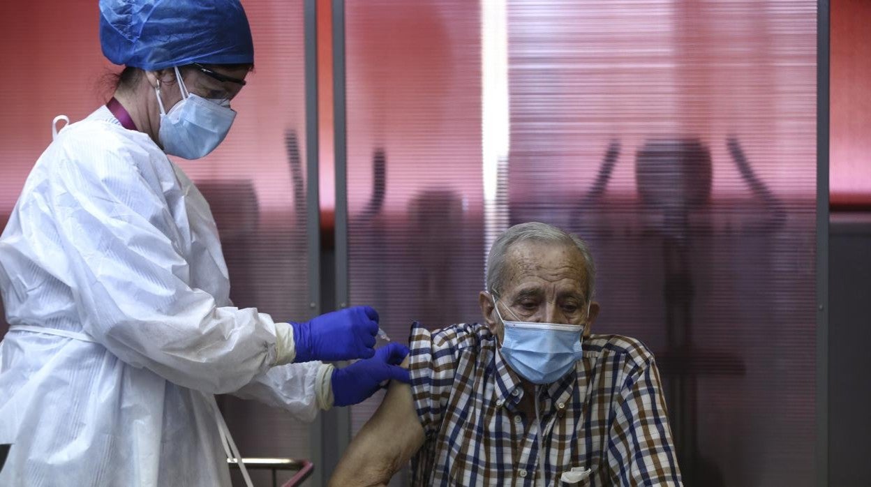 Una sanitaria pone la vacuna a un mayor de una residencia