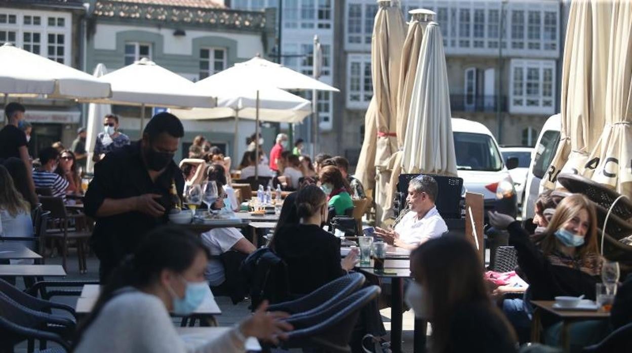 Un camarero atiende a los clientes de un local de hostelería en Santiago de Compostela