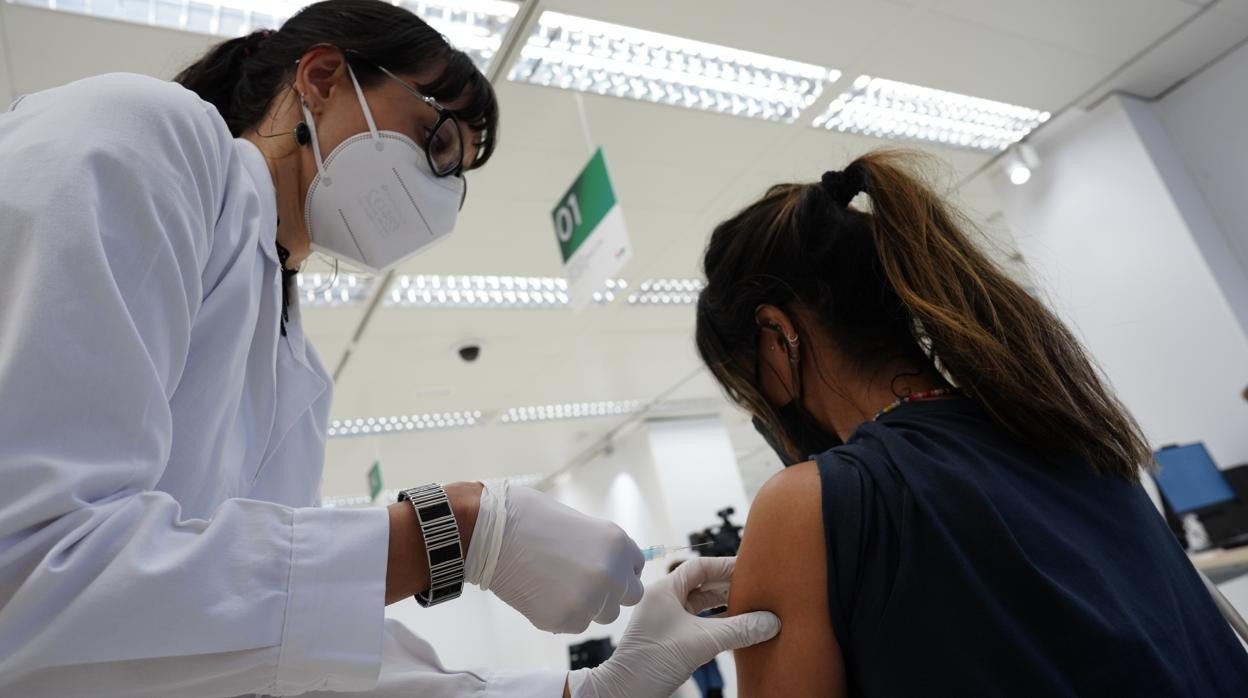 Una sanitaria vacuna contra el coronavirus a una joven en Madrid