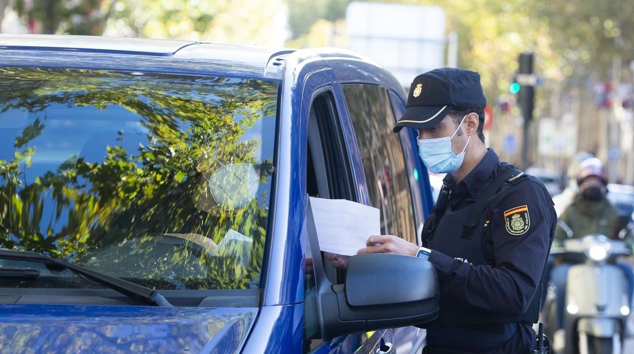 Un Policía Nacional pidiendo la documentación al conductor de un vehículo