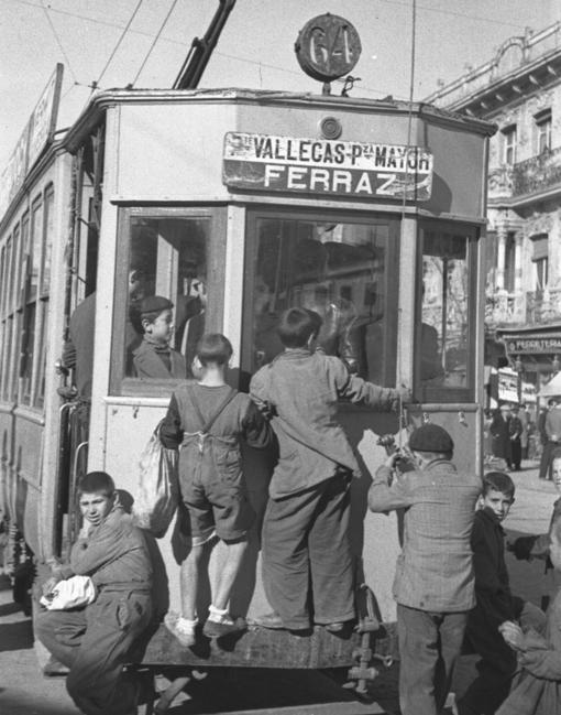 Niños apeados en los topes de un tranvía, una de las imágenes que componen la exposición de la Comunidad de Madrid en la Biblioteca Regional