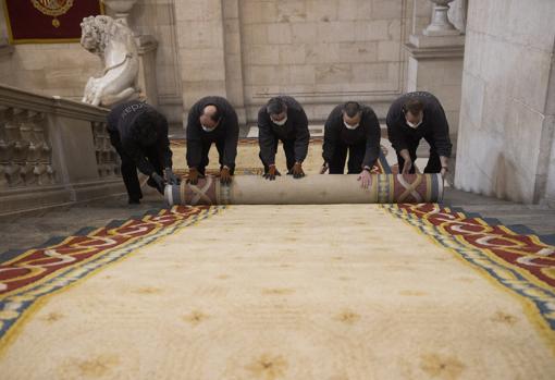 Cinco personas de mantenimiento recogieron los tramos de alfombra de la escalera