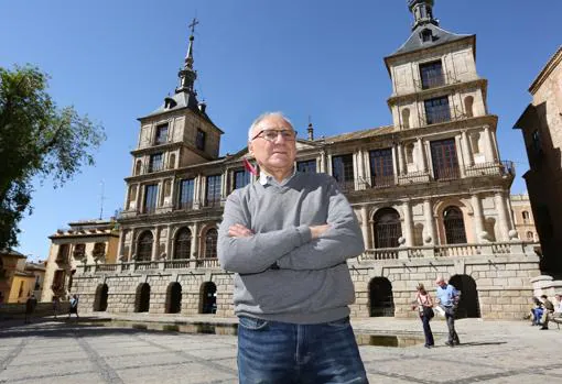 El escritor y periodista Enrique Sánchez Lubián posa con el Ayuntamiento de Toledo detrás