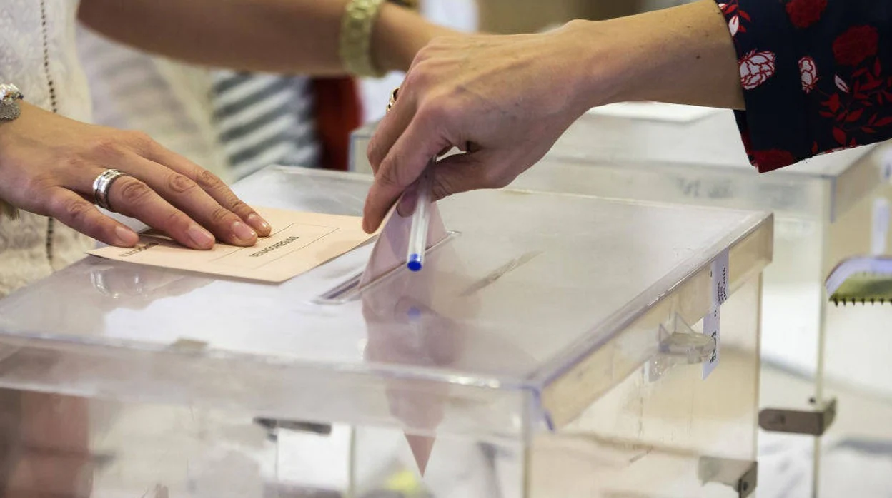 Una mujer deposita su voto en una urna