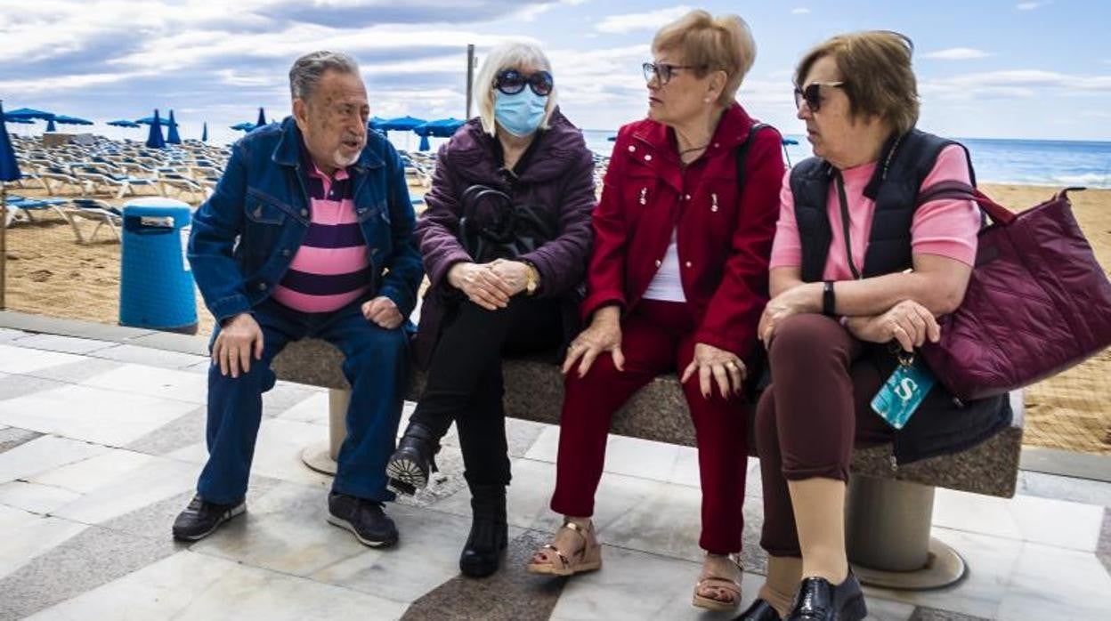 Turistas mayores en la playa en Benidorm