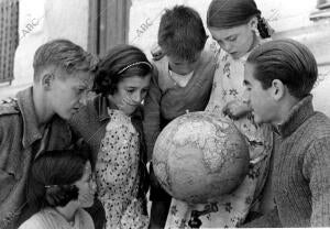 Jóvenes y Niños Observando un globo Terráqueo