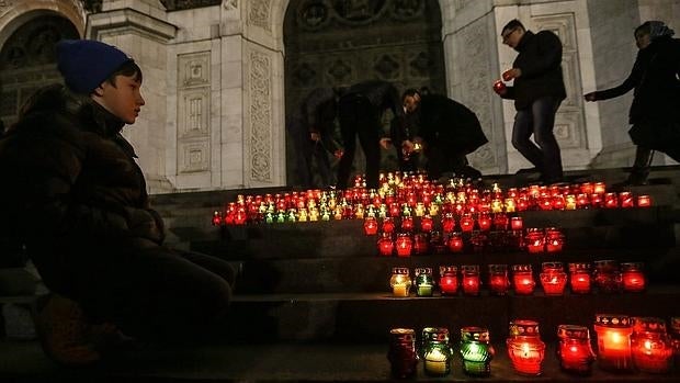 Un grupo de personas enciende velas en Moscú en recuerdo a las víctimas del accidente de avión