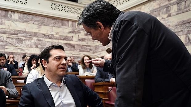 El primer ministro griego, Alexis Tsipras (i) , conversa con su ministro de Finanzas, Euclides Tsakalotos, durante una reunión de su partido en el Parlamento