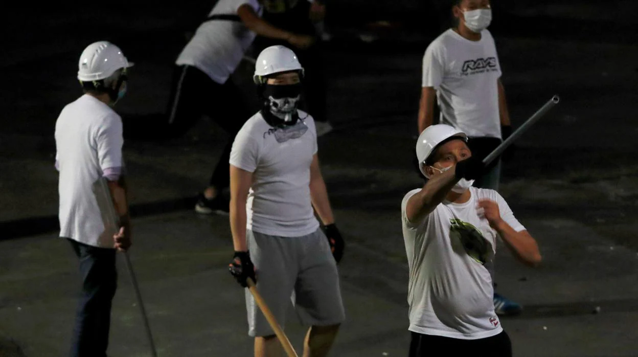 Varios hombres de blanco durante el asalto a una estación de metro de Hong Kong