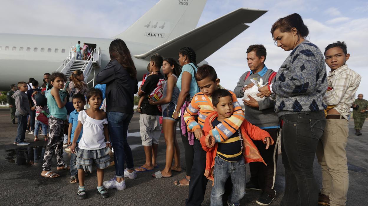 Venezolanos esperan para ingresar a un avión en el aeropuerto de Boa Vista