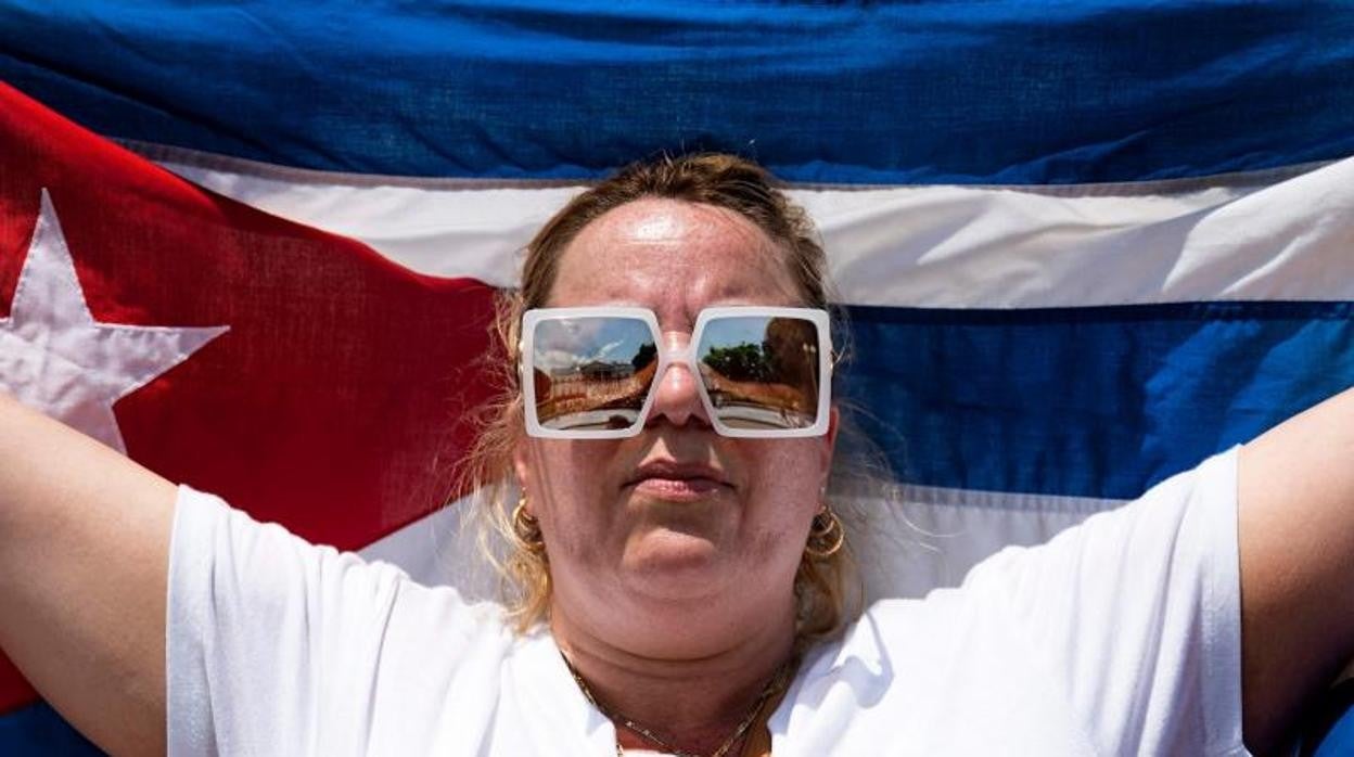 Una manifestante protesta con una bandera cubana frente a la Casa Blanca ayer