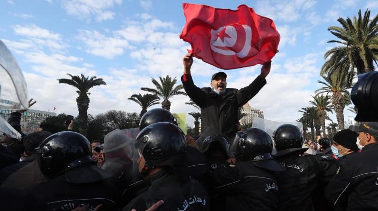 Los manifestantes desafían las restricciones por el Covid-19 en Túnez para protestar contra la suspensión del Parlamento por el presidente tunecino, Kais Saied, coincidiendo con el undécimo aniversario de la salida del poder de Zine el Abidine ben Alí en la llamada Primavera árabe