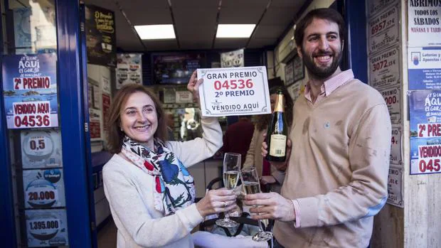 Los propietarios de la administración número 1 de Fuengirola brindan con el cartel del segundo premio