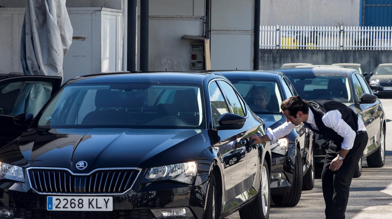 Un conductor limpia su vehículo de Cabify en una imagen de archivo