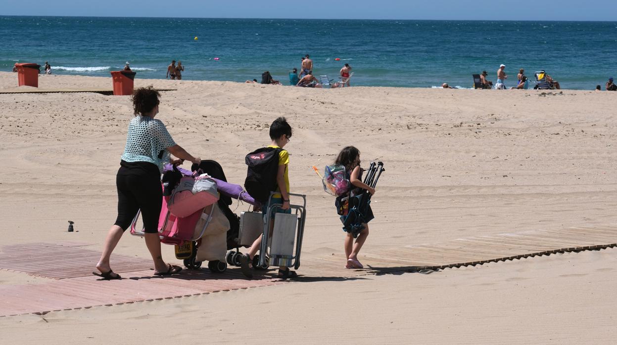 Una familia baja a la playa de Cádiz en primer fin de semana en el que se permitió el baño tras el confinamiento.