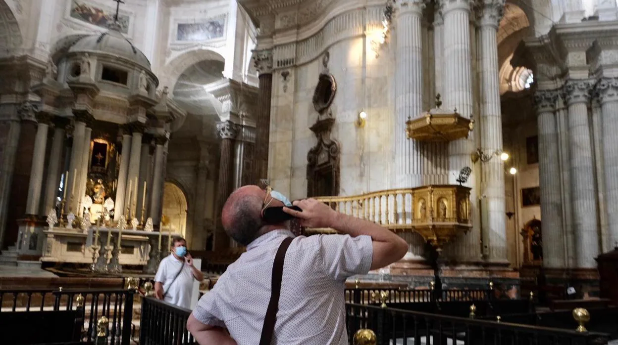 Un turista con su audioguía contemplando la cúpula de la Catedral