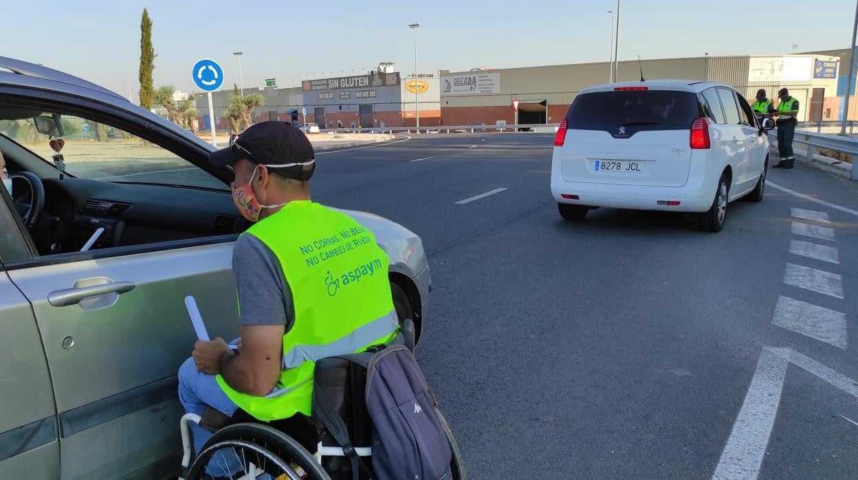 Un voluntario en silla de ruedas informa a un conductor