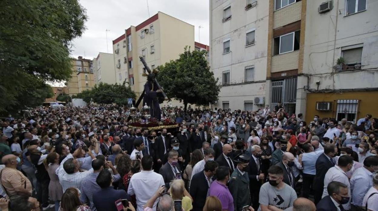 El Señor arropado por la gente del Distrito Tres Barrios-Amate durante su traslado