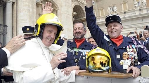 El Papa Francisco con un casco de bomberos tras su encuentro con la brigada de bomberos del la localidad francesa de Fort de Domont en la Plaza de San Pedro