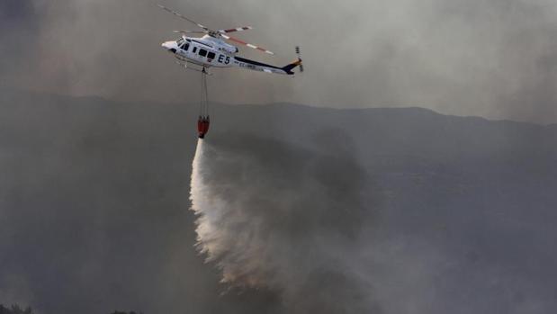 Un helicoptero del Infoca trabajando en labores de extinción en el incendio forestal declarado en Minas de Riotinto (Huelva)