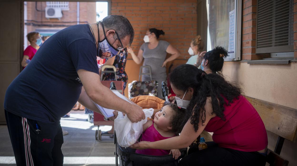 Entrega de alimentos de Cáritas en el barrio de Entrevías de Madrid