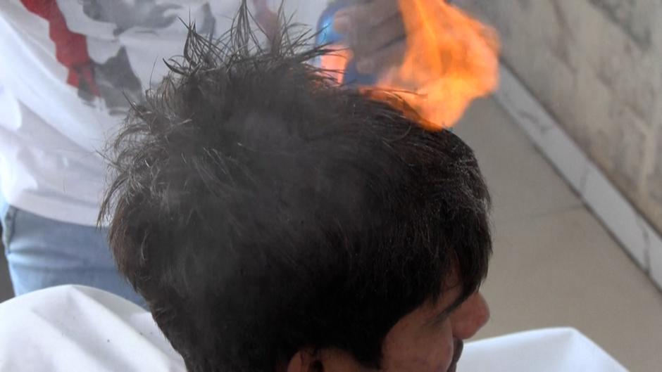 Un peluquero paquistaní ofrece cortes de pelo con cuchillos, martillos y sopletes