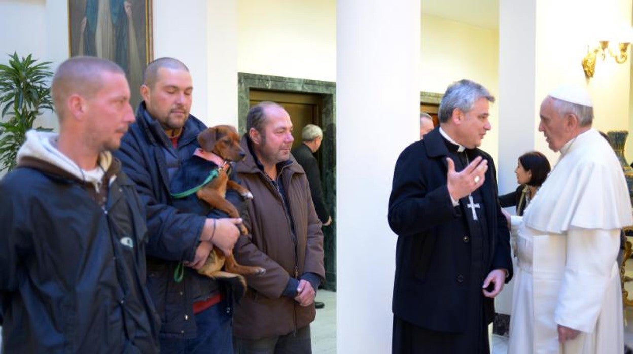 Konrad Krajewski conversa con el Papa Francisco en una imagen de 2013