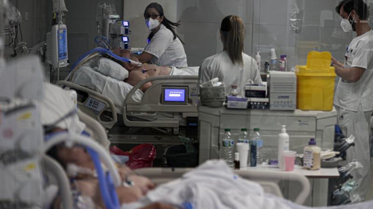 Unos enfermeros atienden a pacientes de Covid en la UCI del Hospital Enfermera Zendal de Madrid