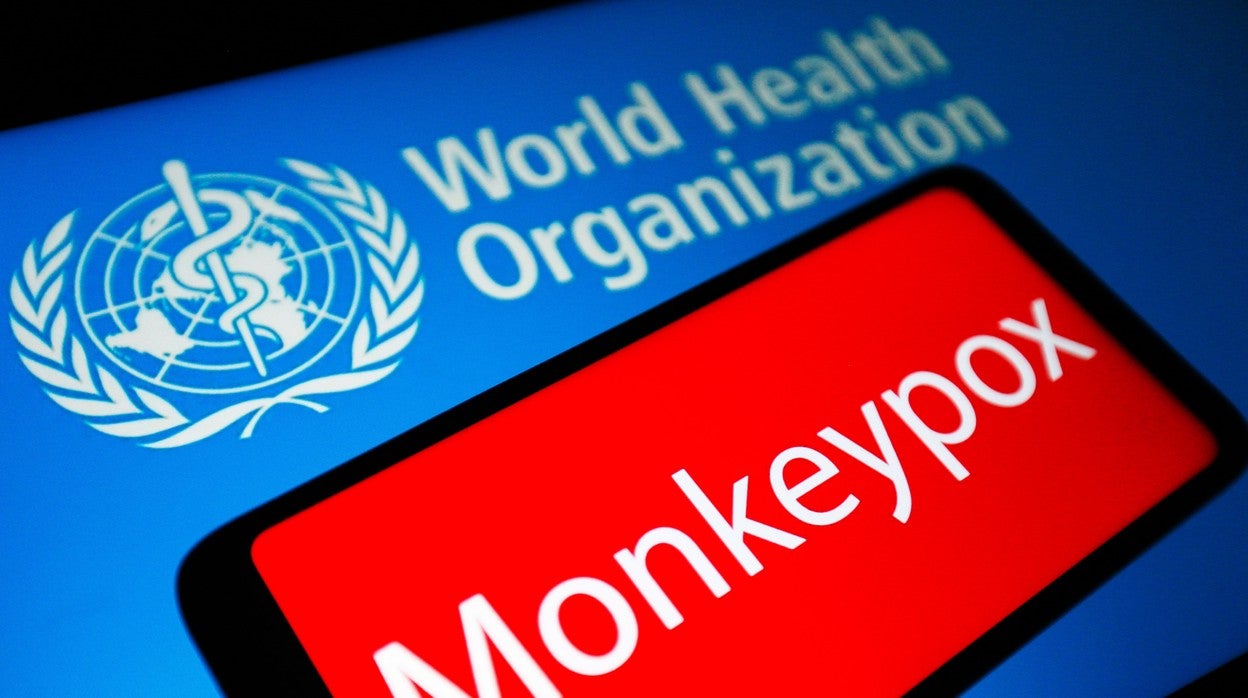 La palabra Monkeypox se ve en la pantalla de un teléfono inteligente y el logotipo de la Organización Mundial de la Salud (OMS)