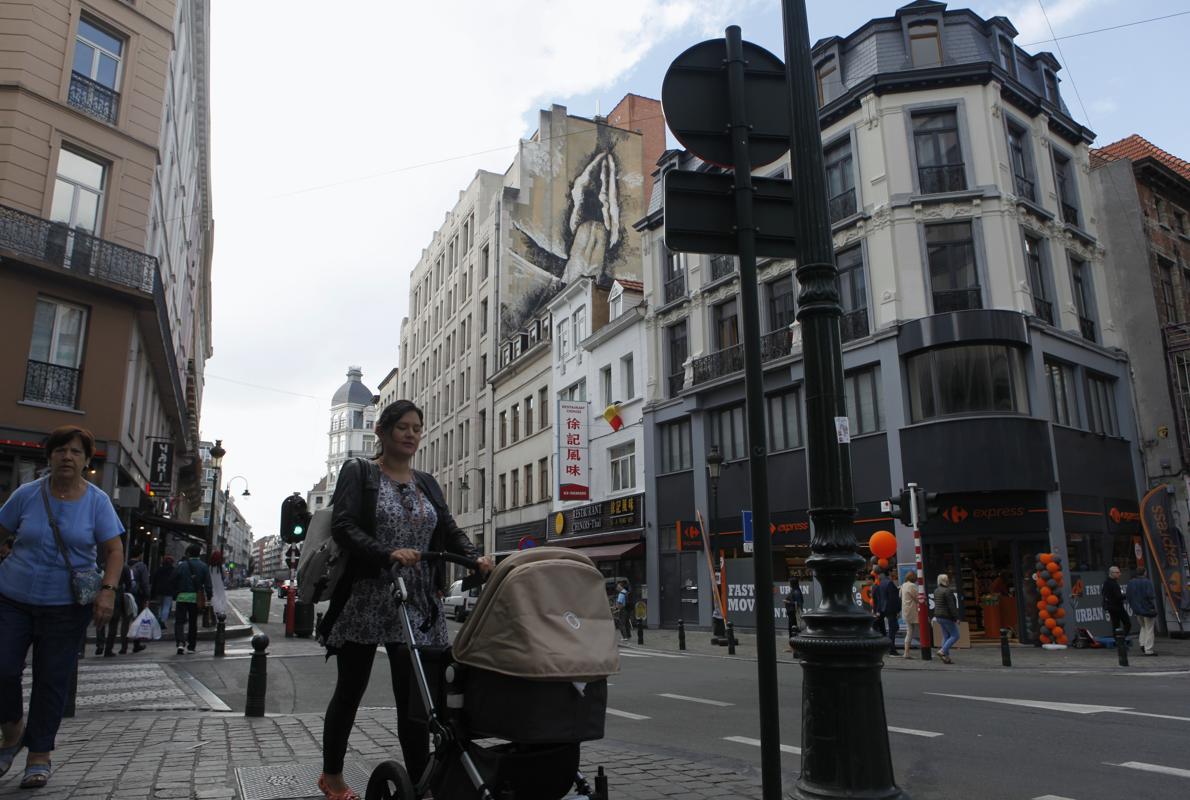 Dos personas fotografían uno de los grafitis de alto contenido sexual que han aparecido en Bruselas